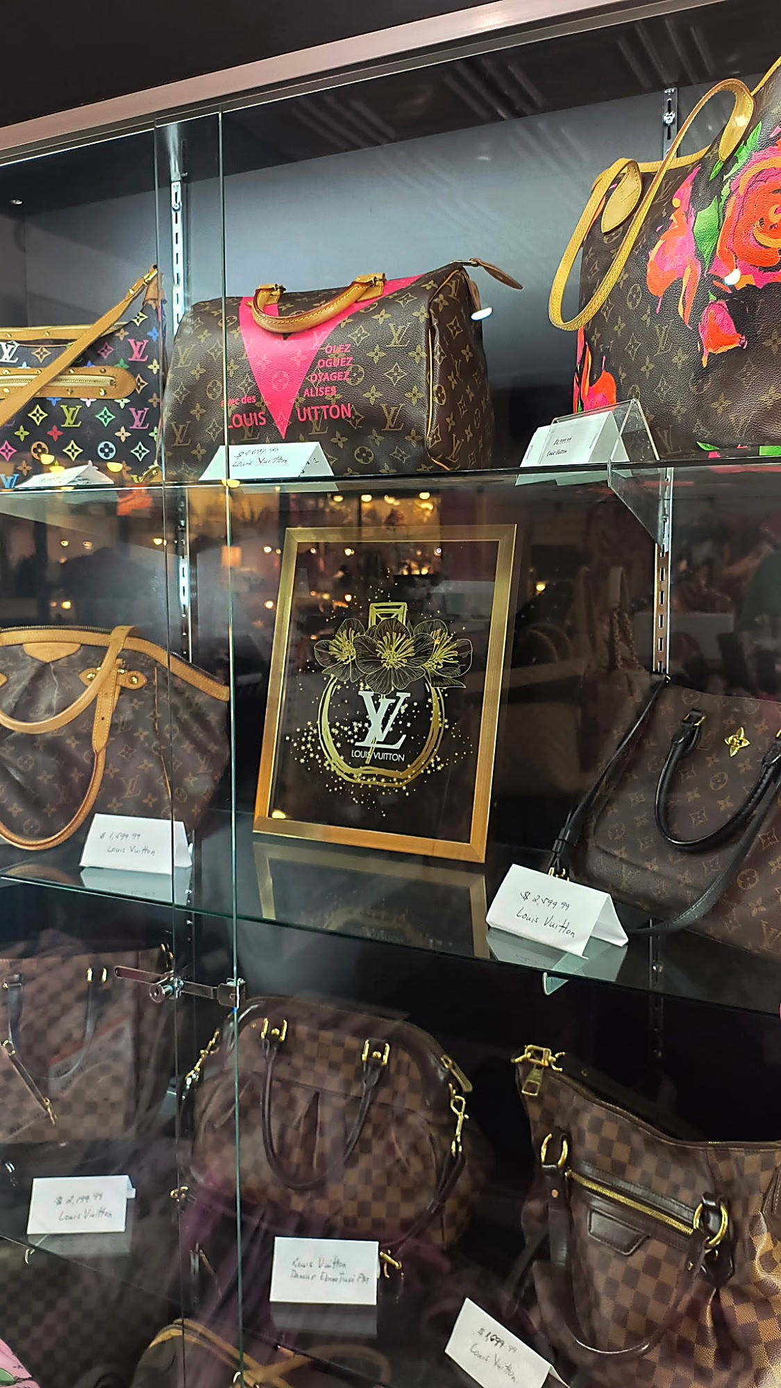A curated collection of designer handbags on a boutique shelf